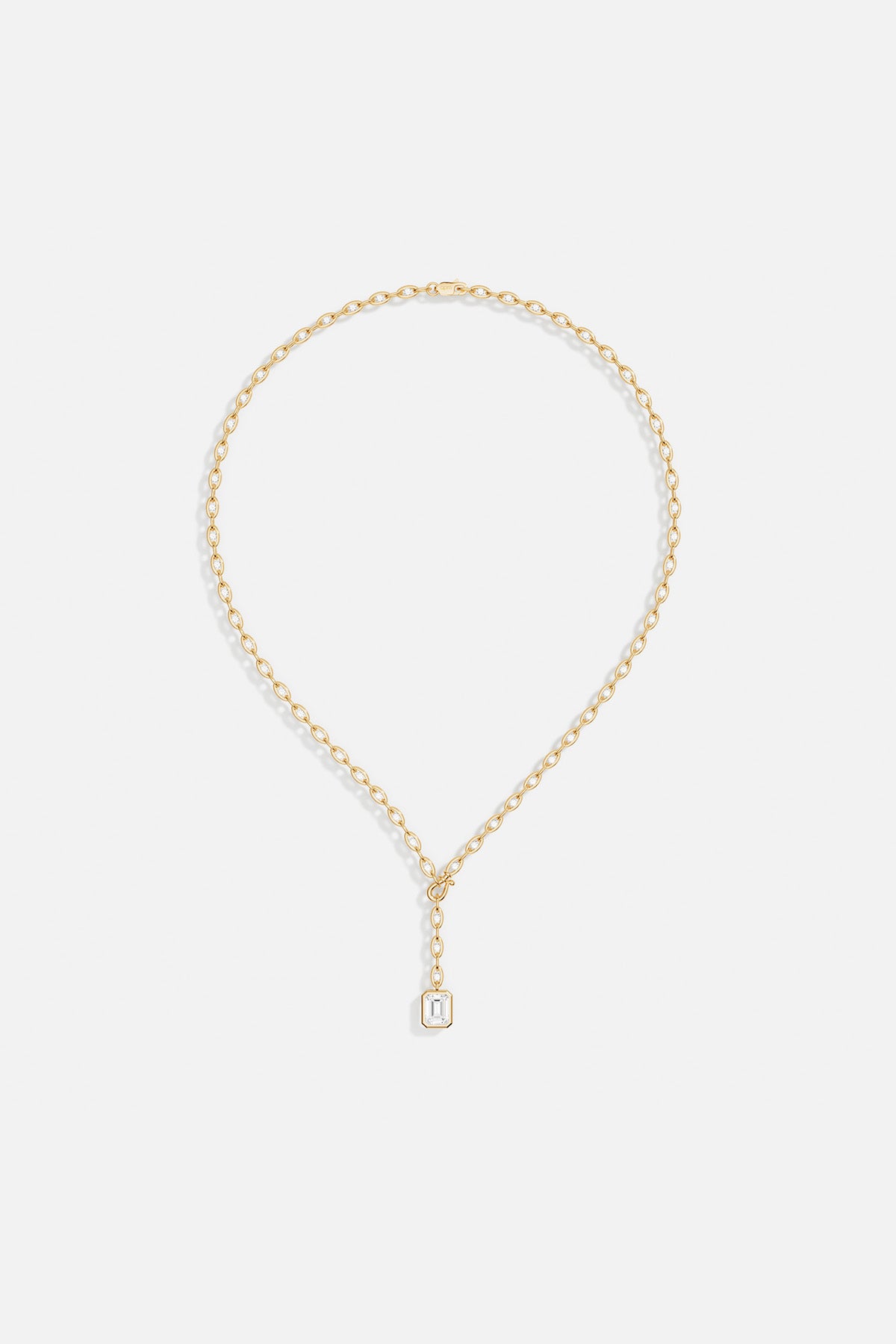 Necklaces APM Monaco: Yellow gold chain with an emerald-cut crystal in a gold bezel pendant, featuring a Y-drop adjustable design.