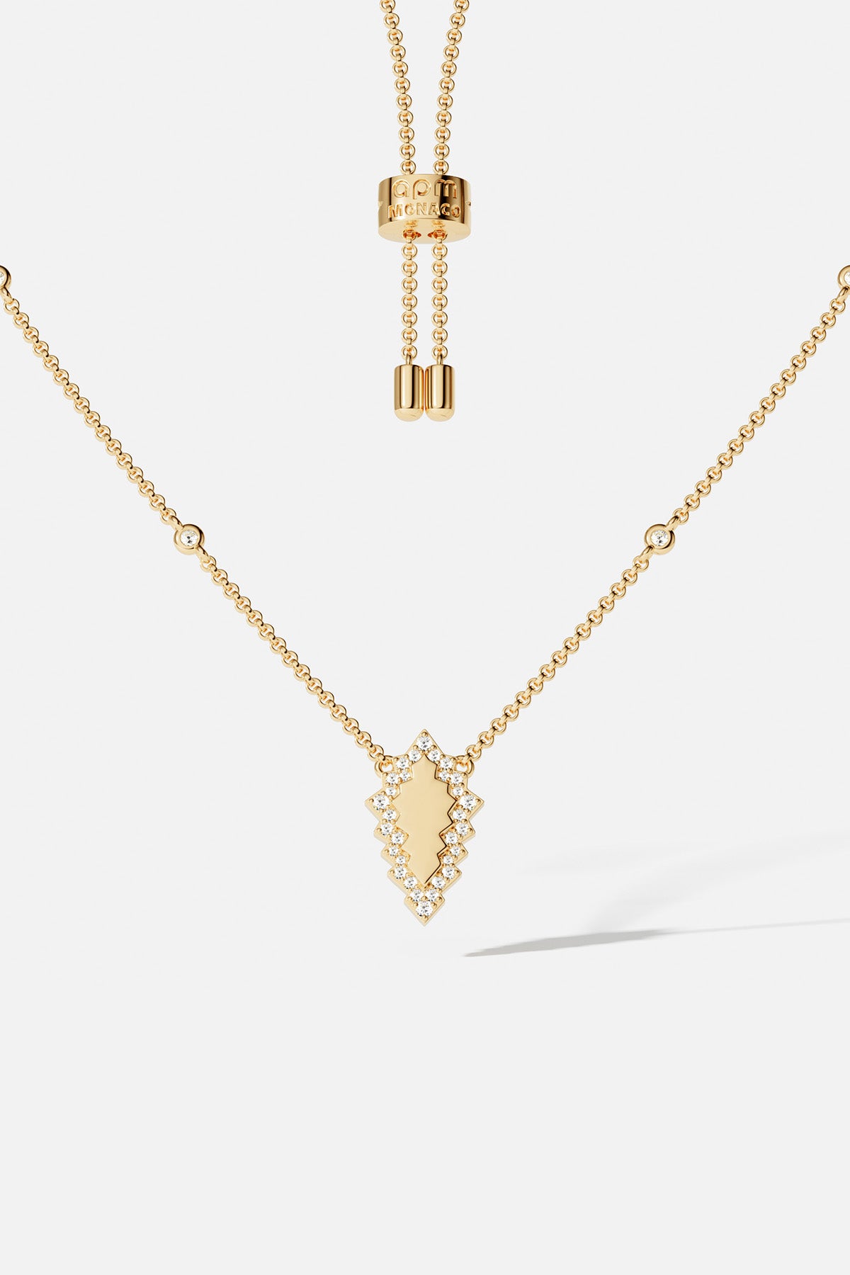 Necklaces APM Monaco, yellow gold adjustable necklace with an arrowhead pendant surrounded by pavé clear stones.