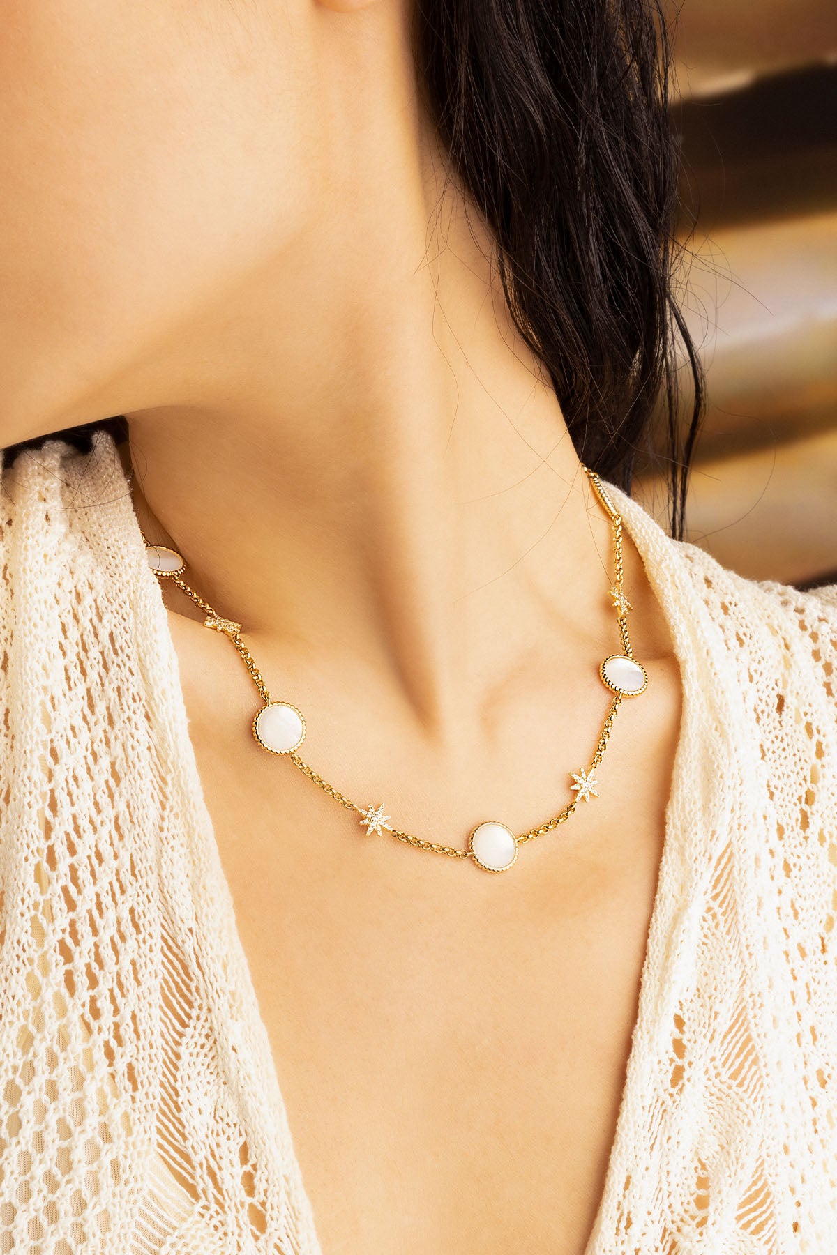 Necklaces APM Monaco, gold-tone choker with white nacre discs and small star charms.