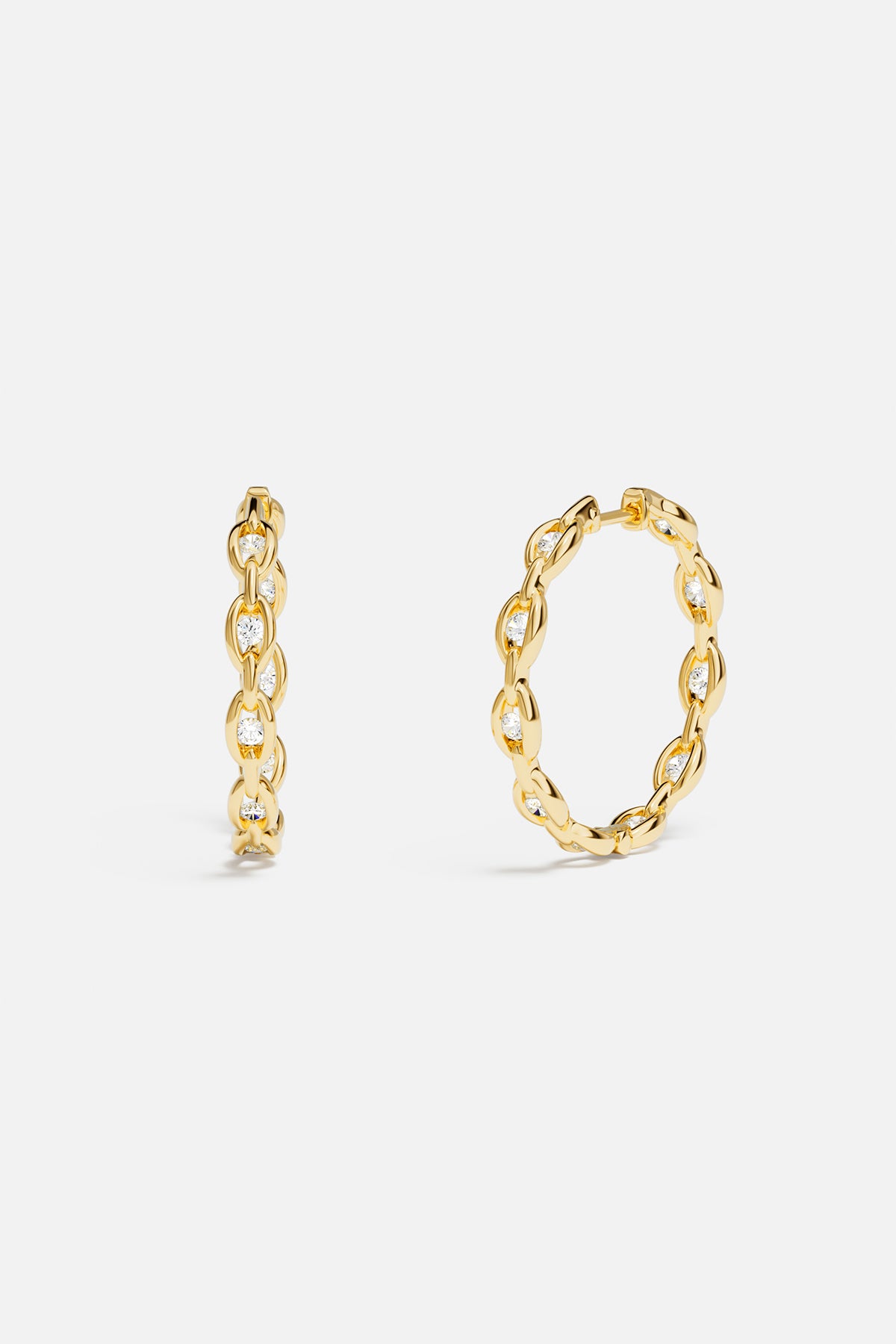 Earrings APM Monaco: yellow-gold pavé chain hoops with white diamonds.
