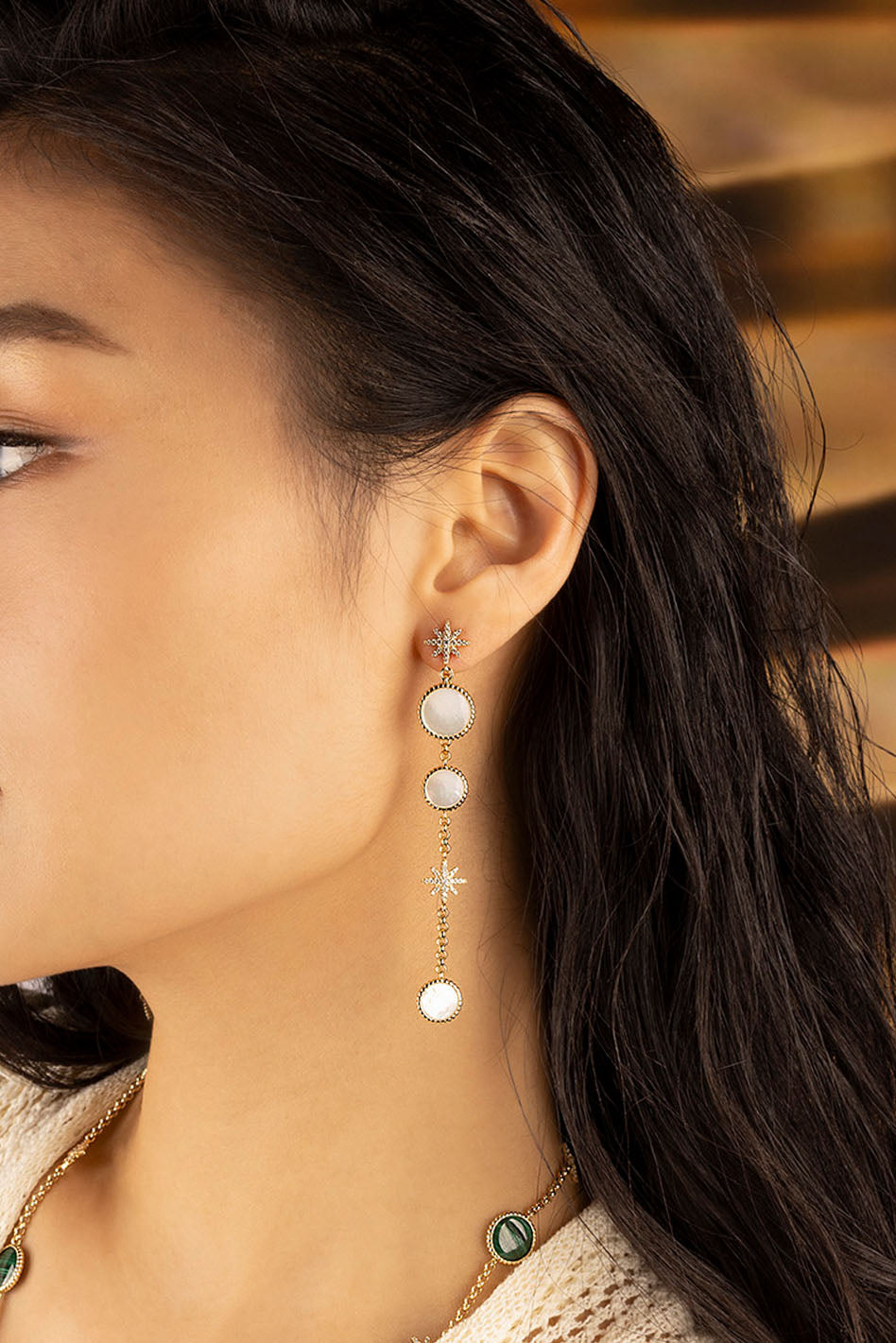 Earrings APM Monaco. White nacre ear jackets in gold-tone metal.