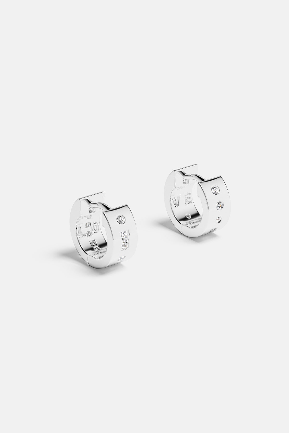 APM Hoop Earrings in rhodium finish, a bright whisper of modern elegance.