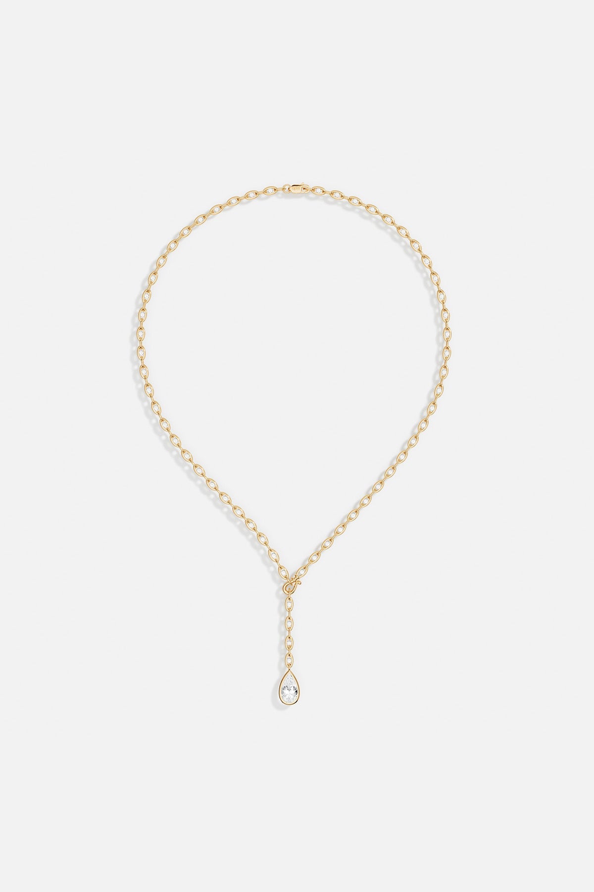APM Necklace in golden color, a delicate teardrop falling with quiet elegance.