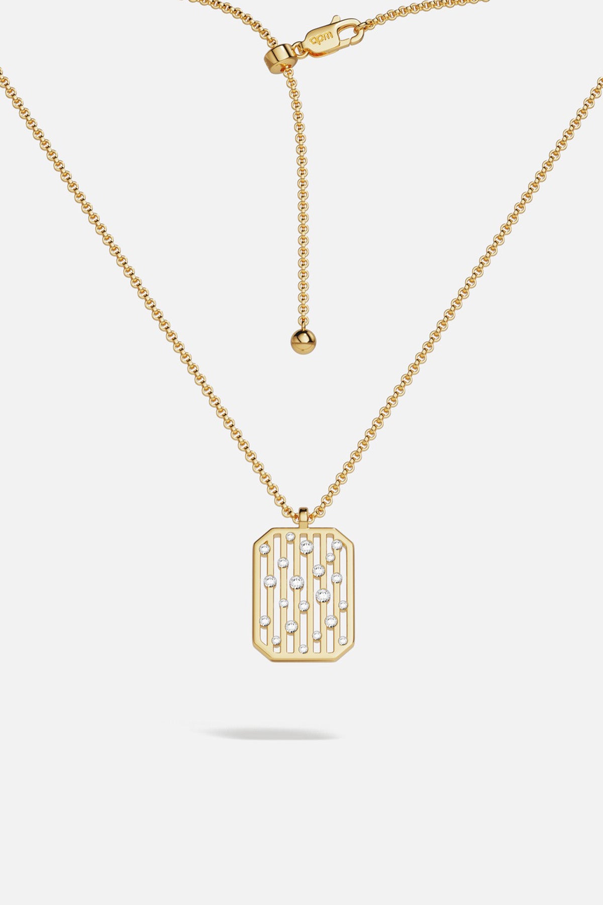 APM Pendant Necklace in golden hue, a modern talisman with quiet sparkle.