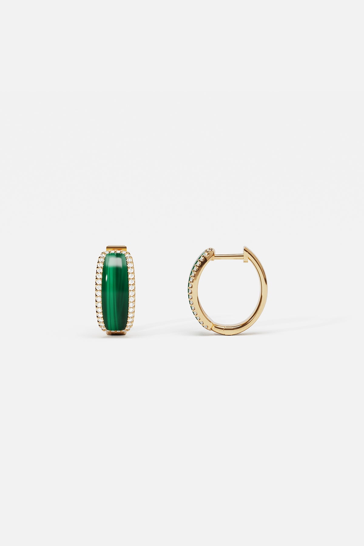 APM Monaco hoop earrings in golden hues and vivid green, quietly radiant elegance.