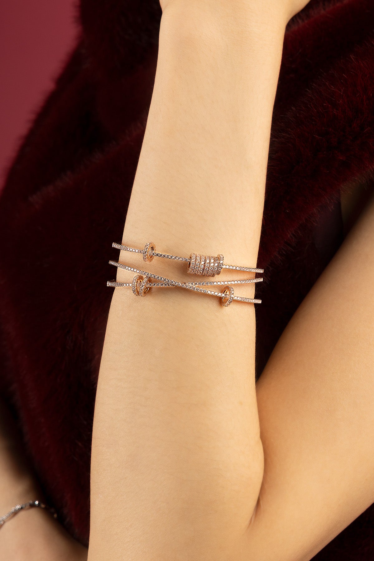 Woman wearing APM Monaco bracelet, a shimmering rose glow of quiet confidence.