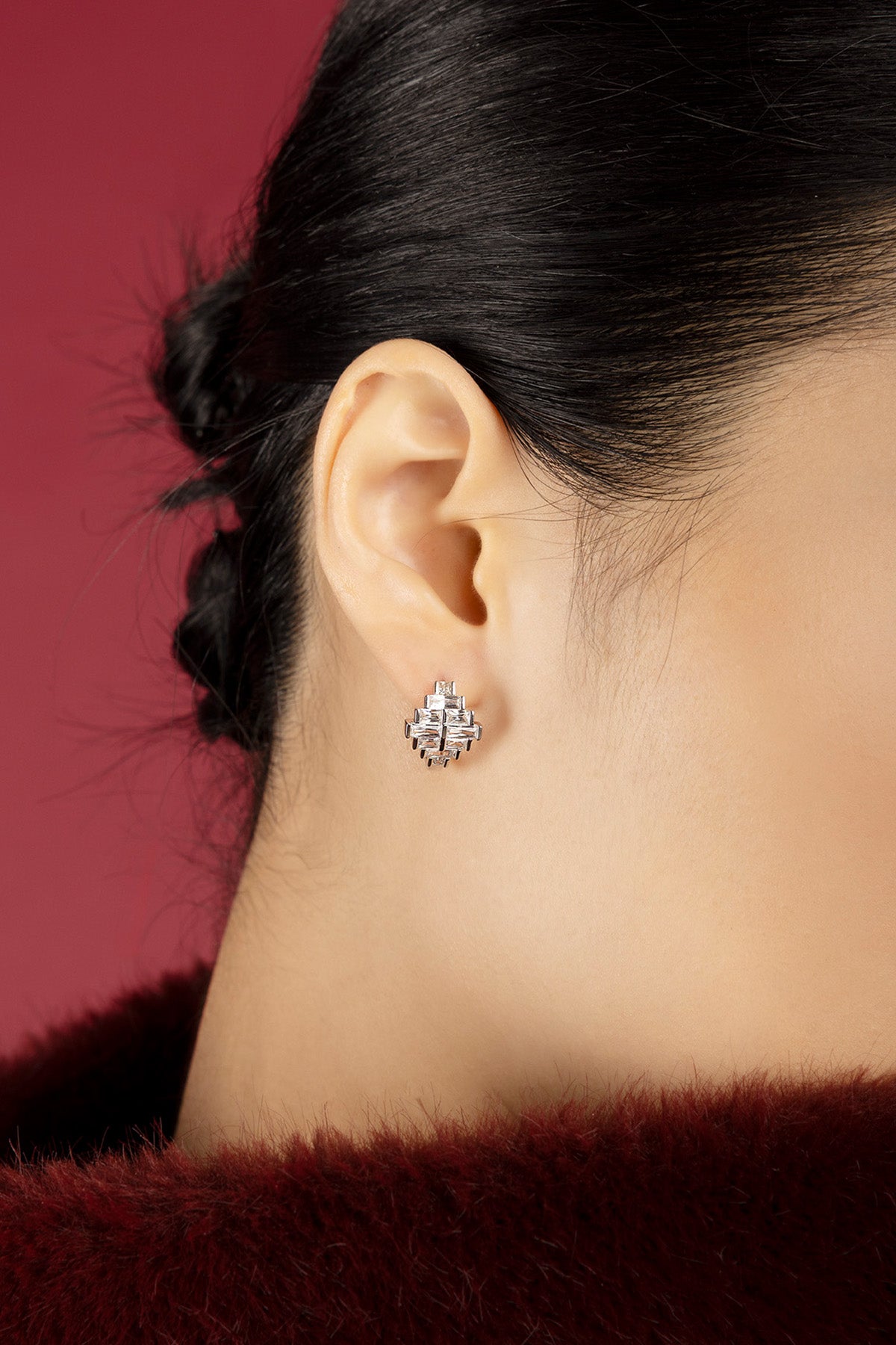 Woman wearing APM Monaco earrings, a sparkling geometric statement with quiet elegance.