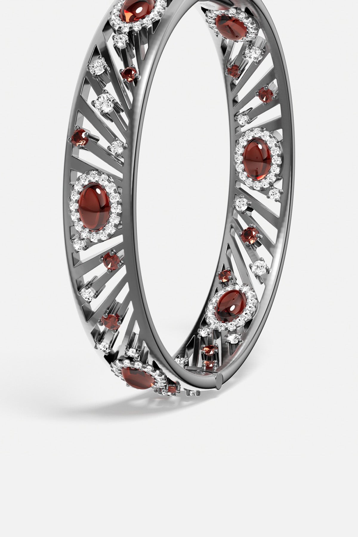 APM Bangle in rhodium finish, radiant with deep red stones and crystalline sparkle.