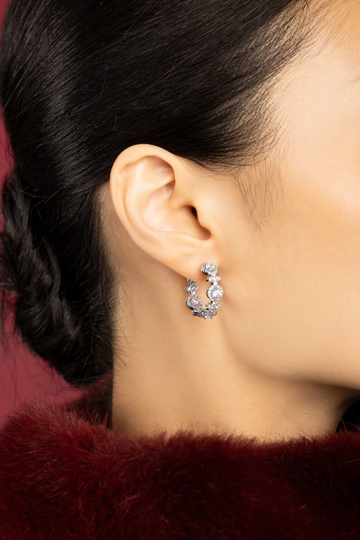 Woman wearing APM Hoop Earrings, a shimmering whisper of modern elegance.