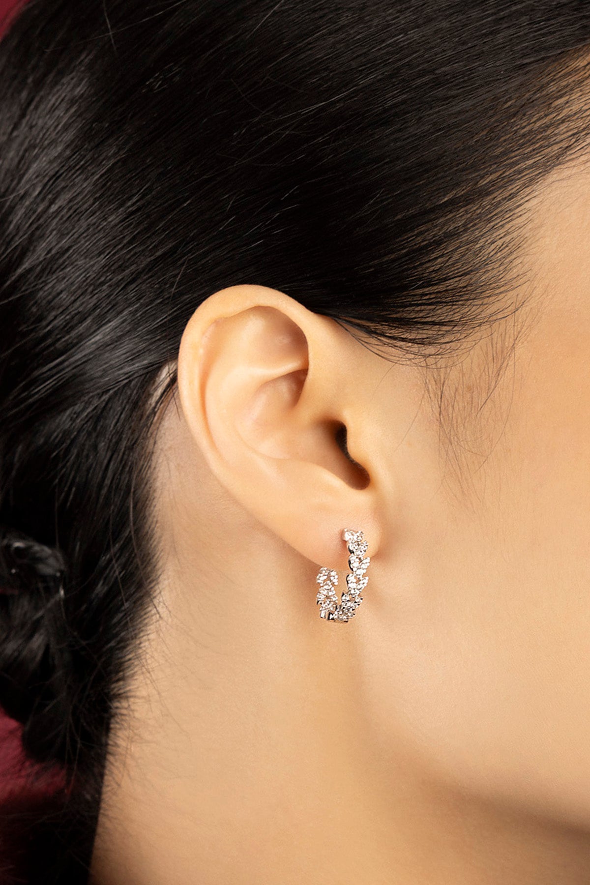 Woman wearing APM Hoop Earrings, a delicate sparkle of effortless modern elegance.