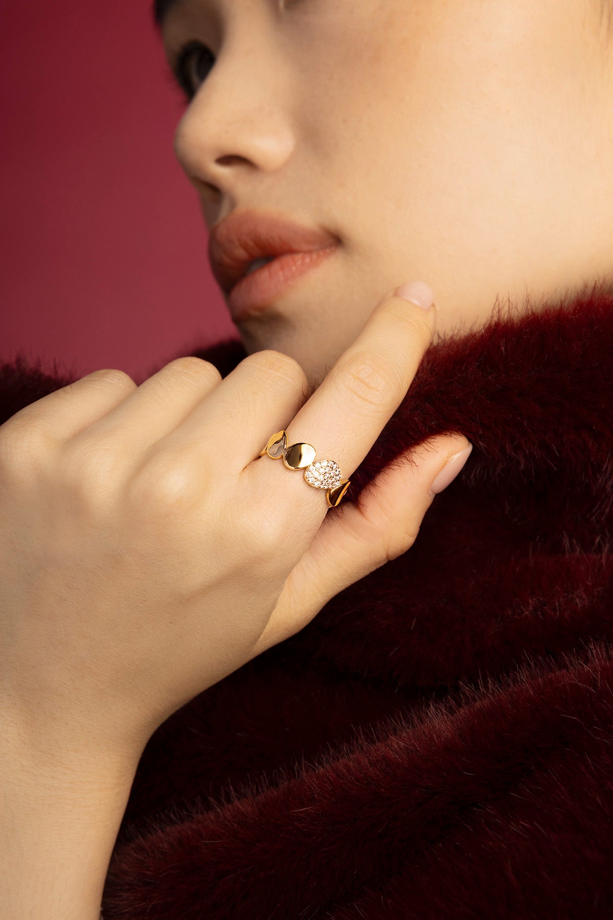 Woman wearing APM rings, a golden whisper of quiet elegance.