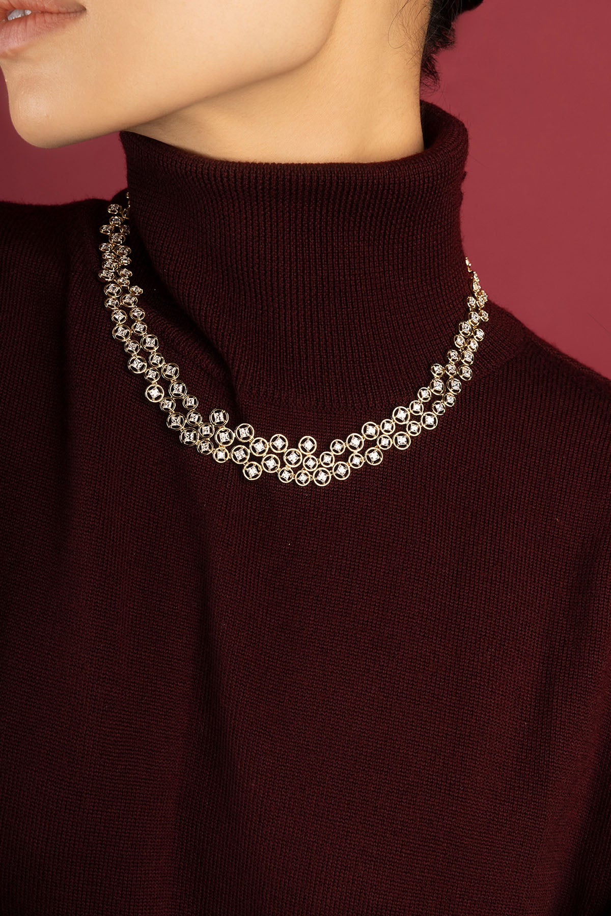 Woman wearing APM necklace, a shimmering cascade of quiet elegance.