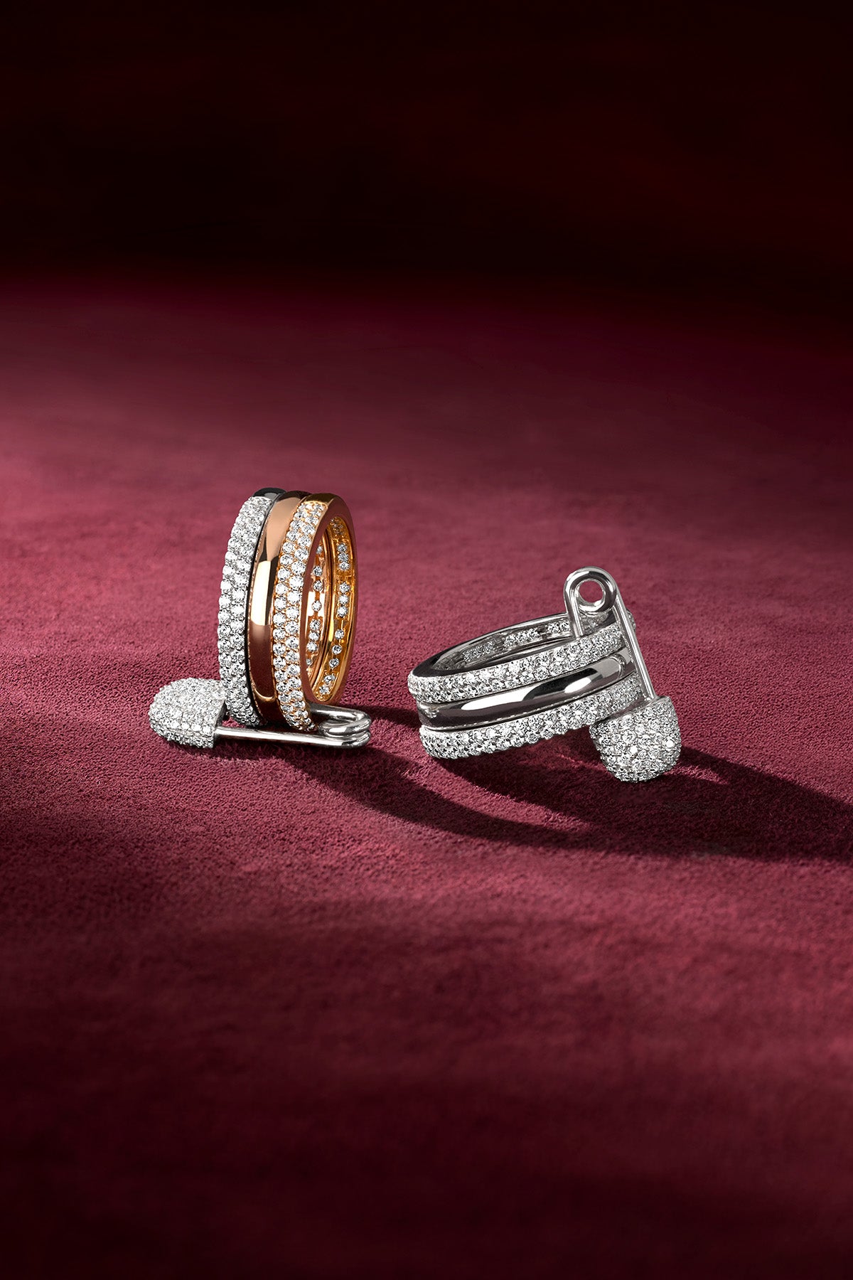 APM Rings shimmering on velvet, a bold duo of rhodium finish and rose glow.