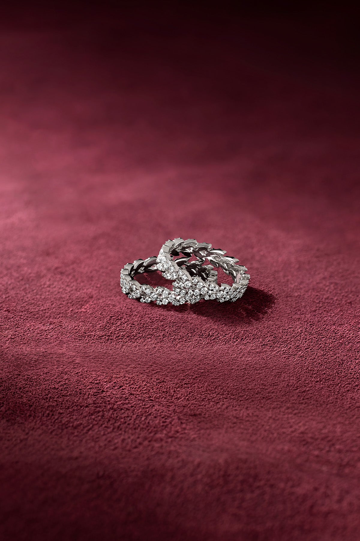 APM Rings resting on velvet, a shimmering duo of quiet elegance.