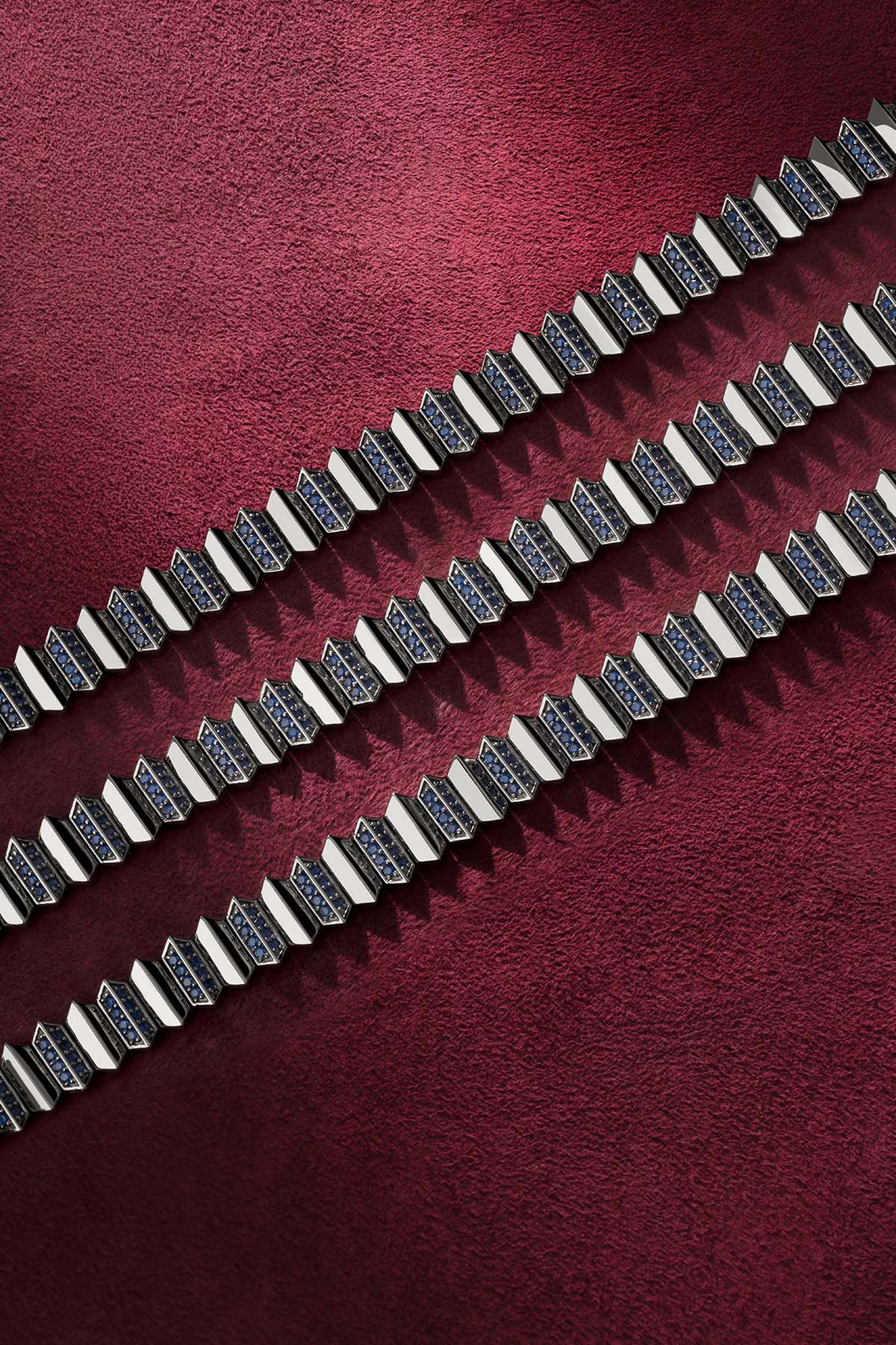 APM Chain Bracelet, bold geometry with deep blue stones on rhodium finish.