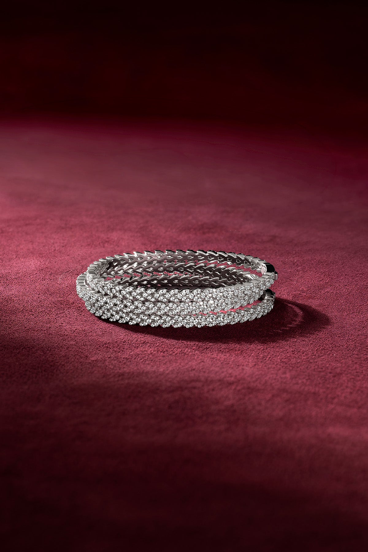 APM Monaco bangles in rhodium finish, sparkling with quiet confidence on velvet.