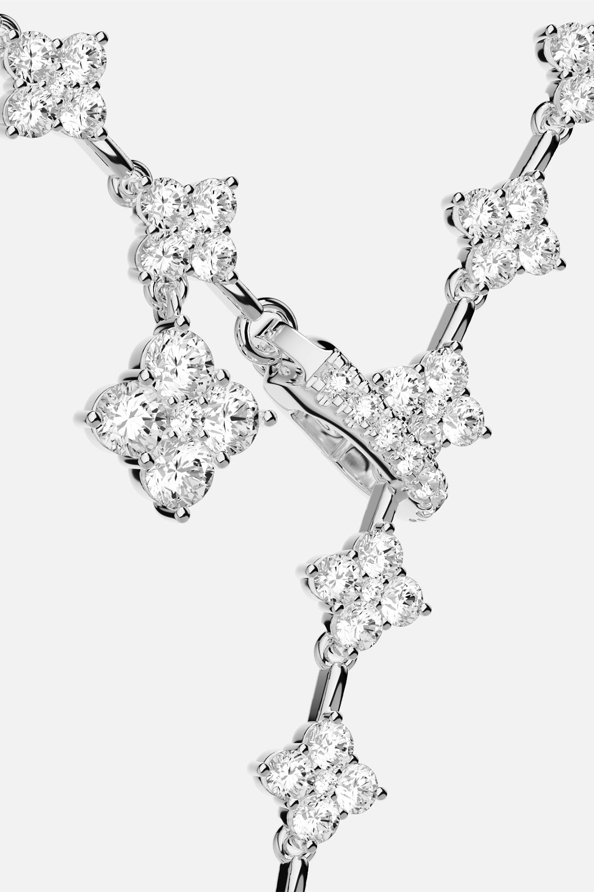 APM Necklace, a shimmering cascade of clovers in rhodium finish brilliance.