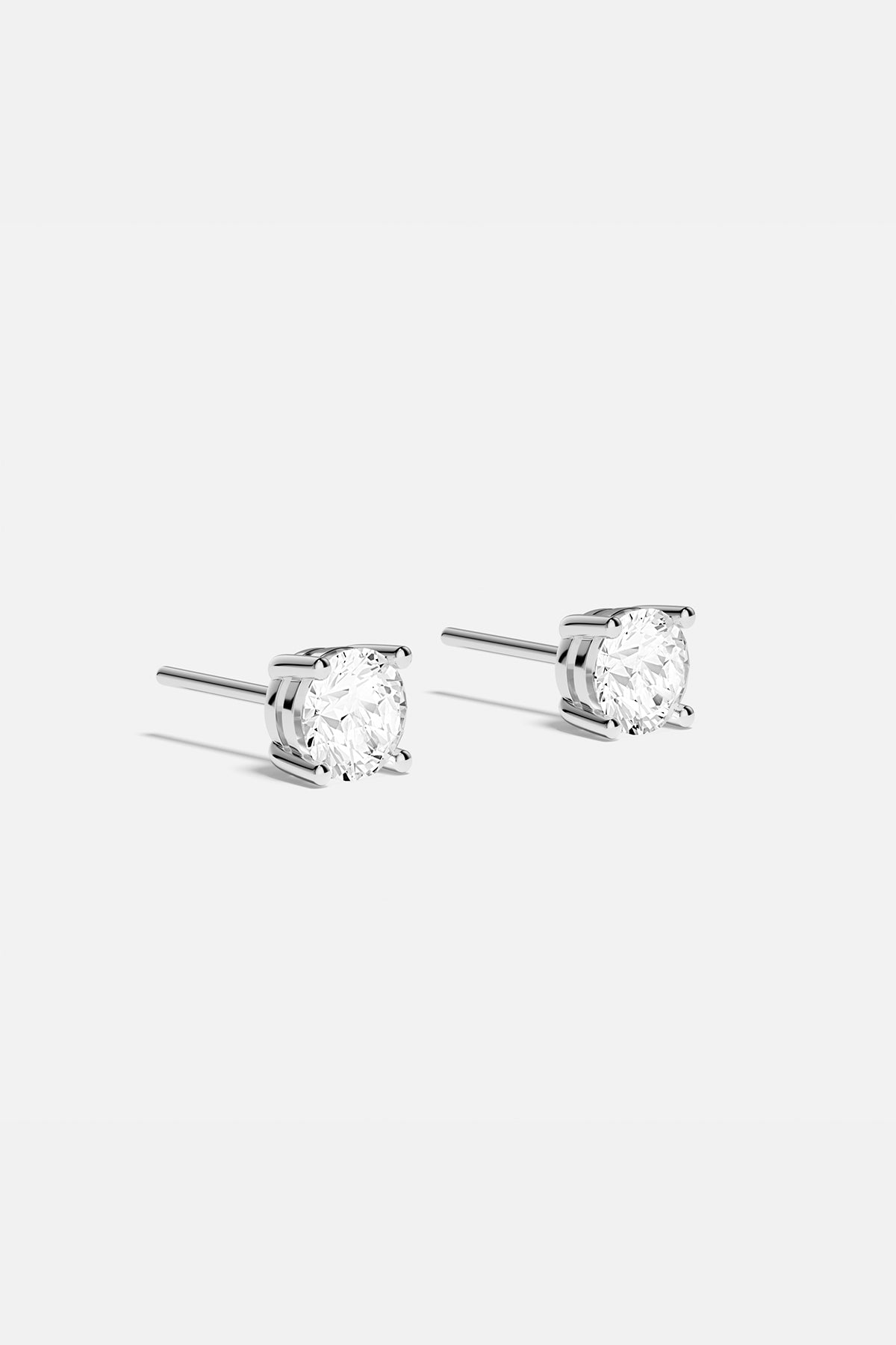 APM Stud Earrings, a timeless sparkle in radiant rhodium finish.