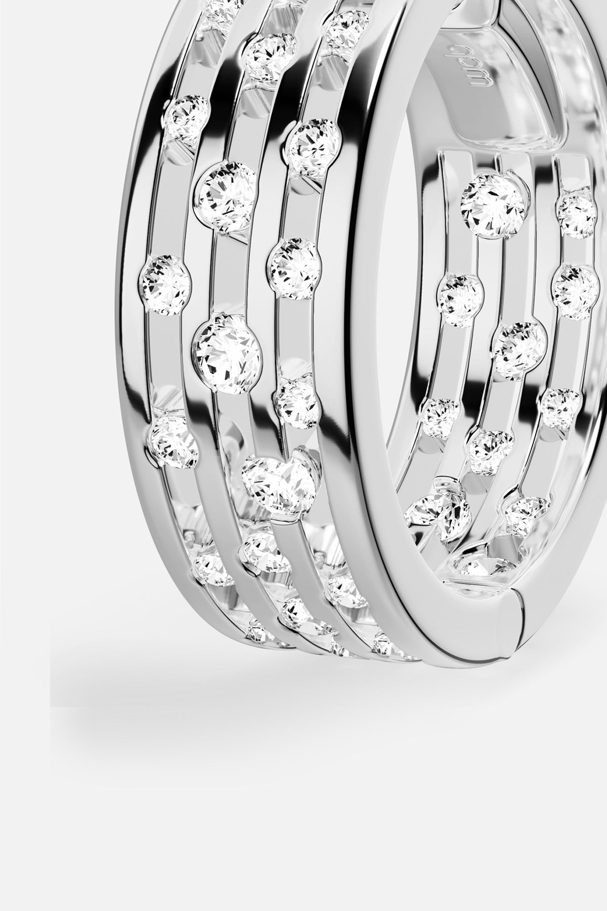 APM Ring in rhodium finish, scattered stones dancing with quiet, modern brilliance.