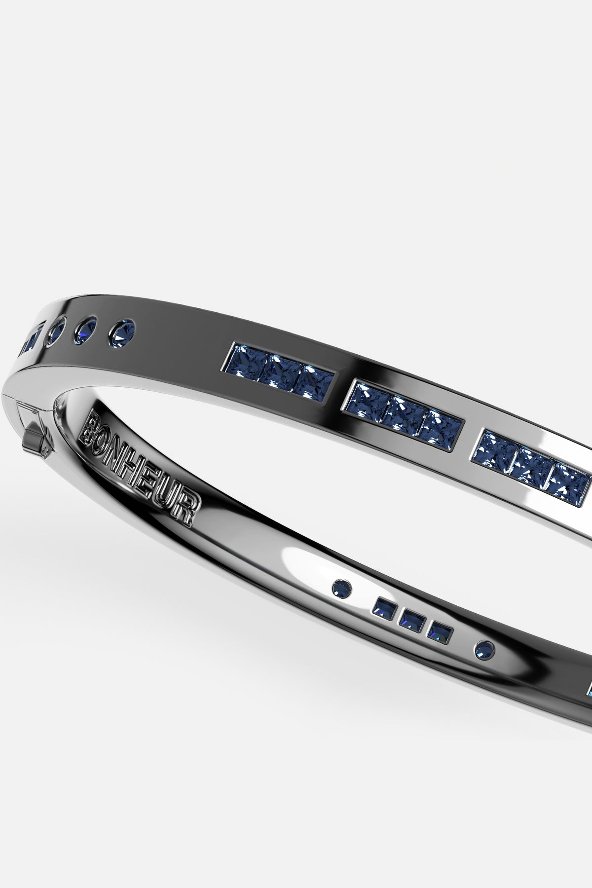 APM Bonheur Bangle in rhodium finish, midnight blue stones whispering quiet confidence.