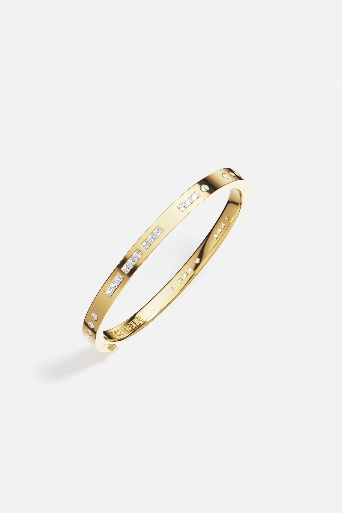 APM Bonheur Bangle in golden color, a modern signature of quiet luxury.