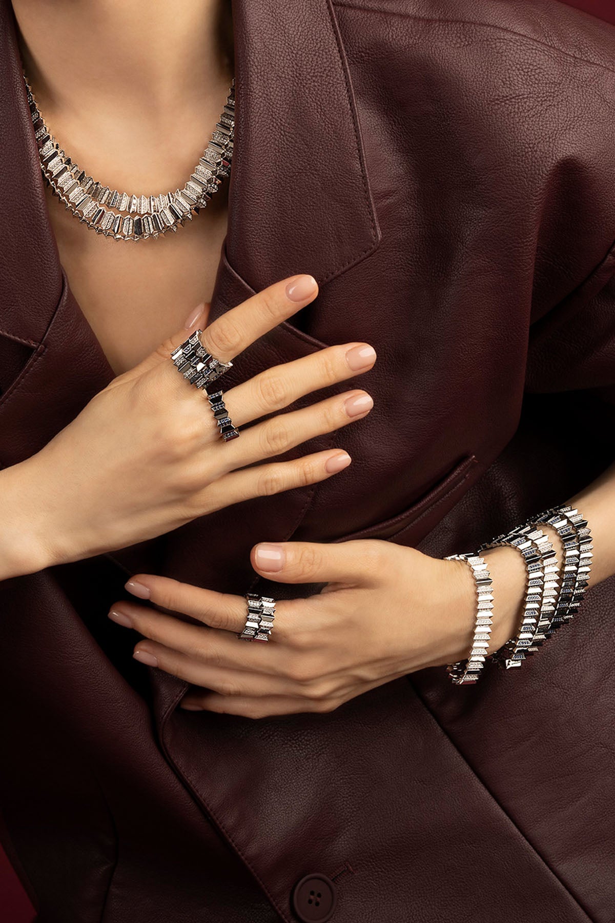 Woman wearing APM Morse jewelry set, bold elegance in rhodium finish.