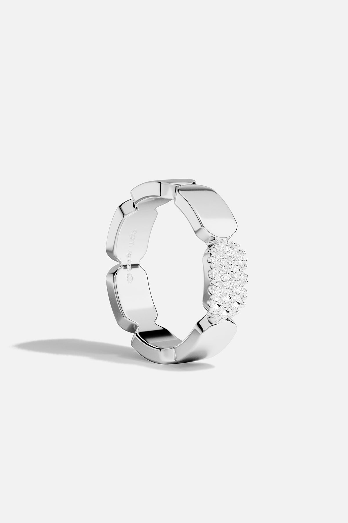 Silver ring with white stones on a white background