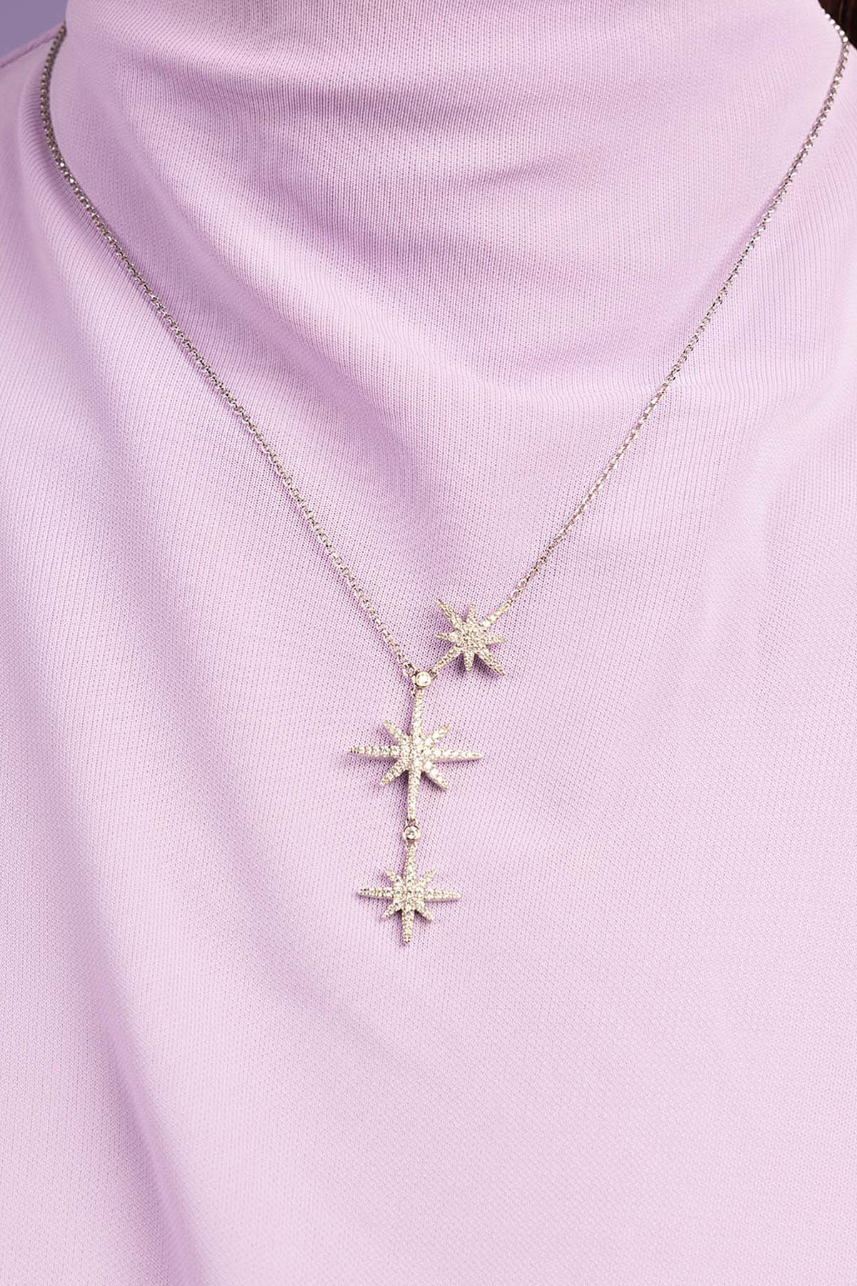 APM Monaco Triple Meteorites Adjustable necklace wearing a light purple top against a purple background
