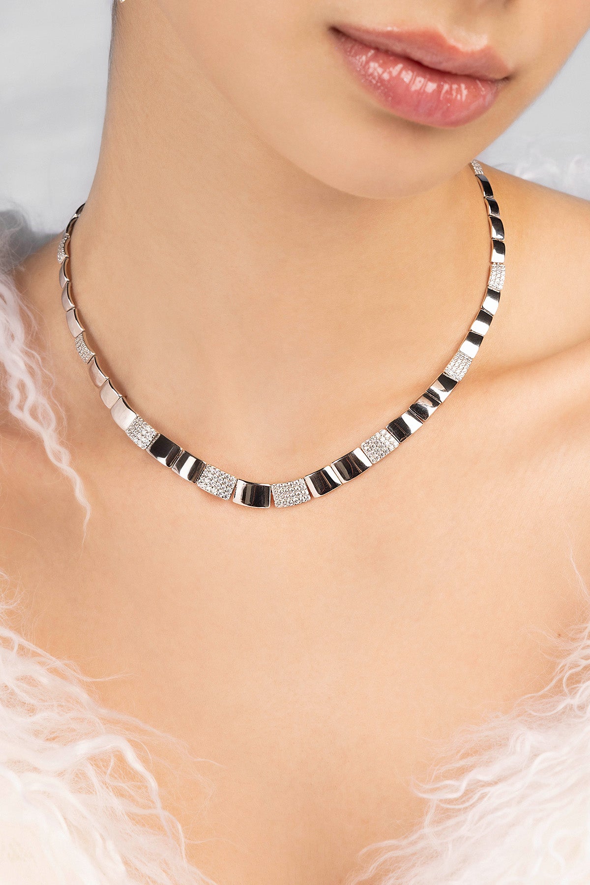 Necklace with black and silver square pattern worn by a model
