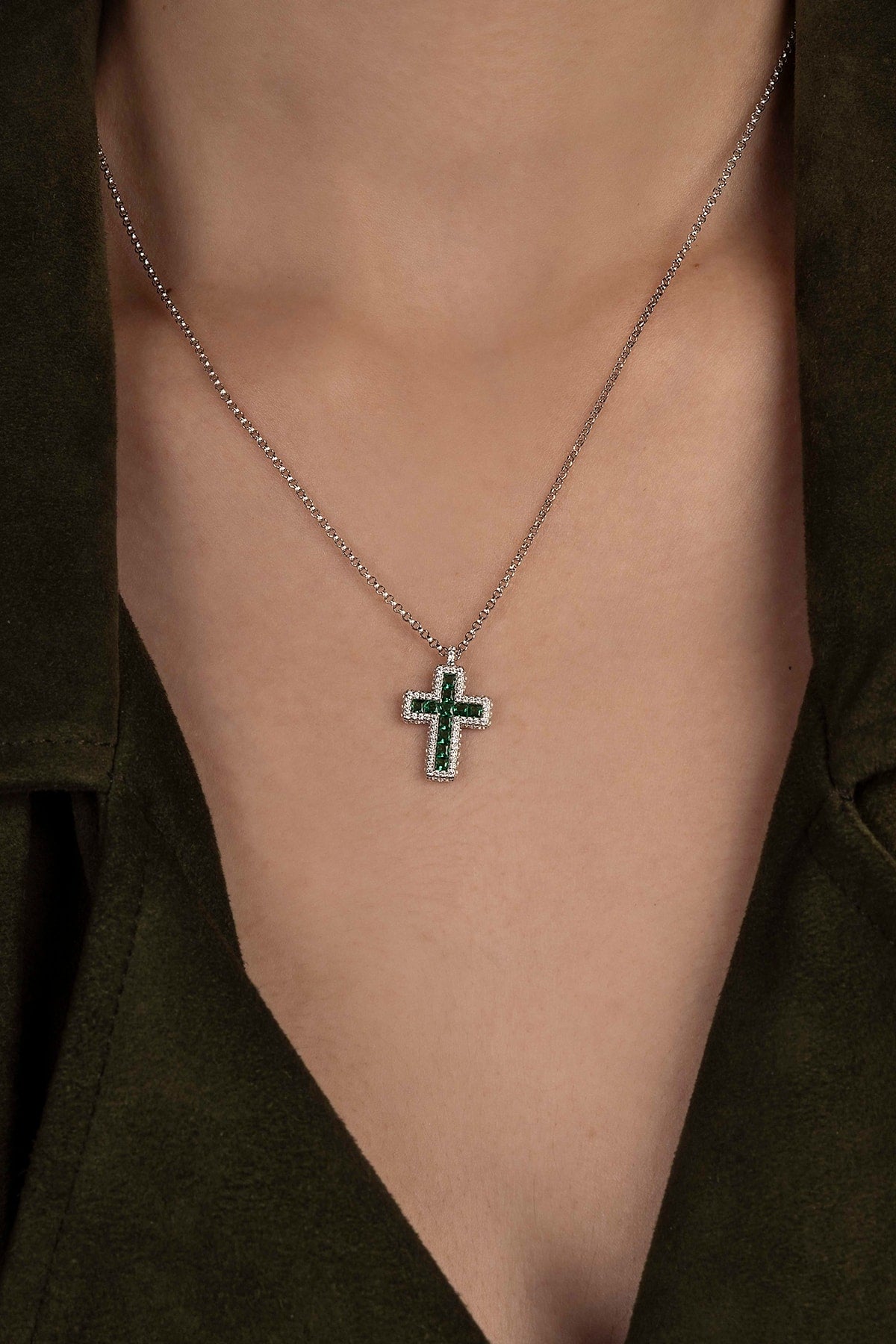 Necklace with a cross pendant on a model 