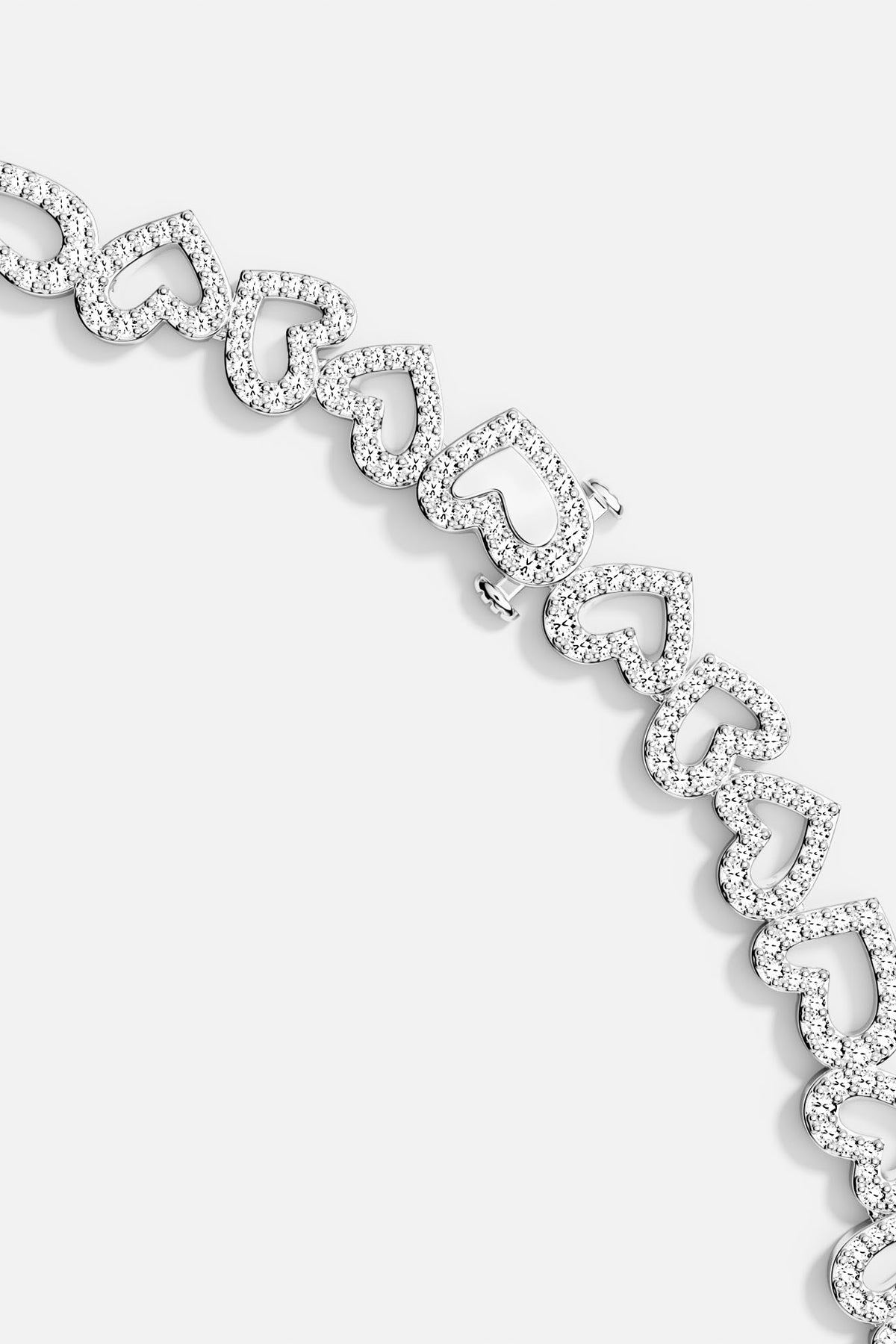Close-up of heart-shaped bracelet in silver on a light gray background