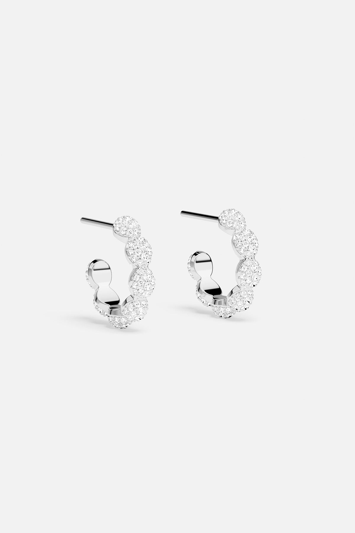 Pair of silver hoop earrings on a white background