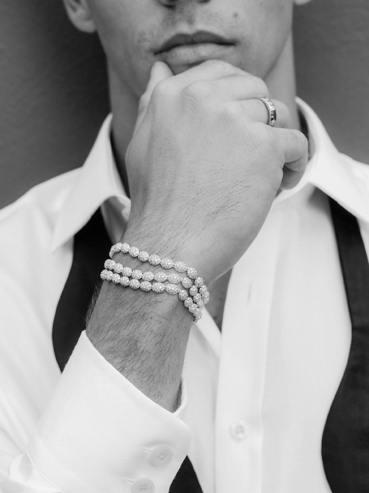 Person wearing APM MONACO pave bracelet in silver with a blurred background