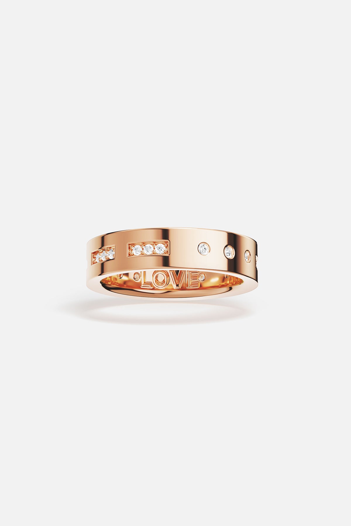 Rings APM Monaco. Rose gold ring featuring a LOVE Morse-code design with small diamonds and star accents.