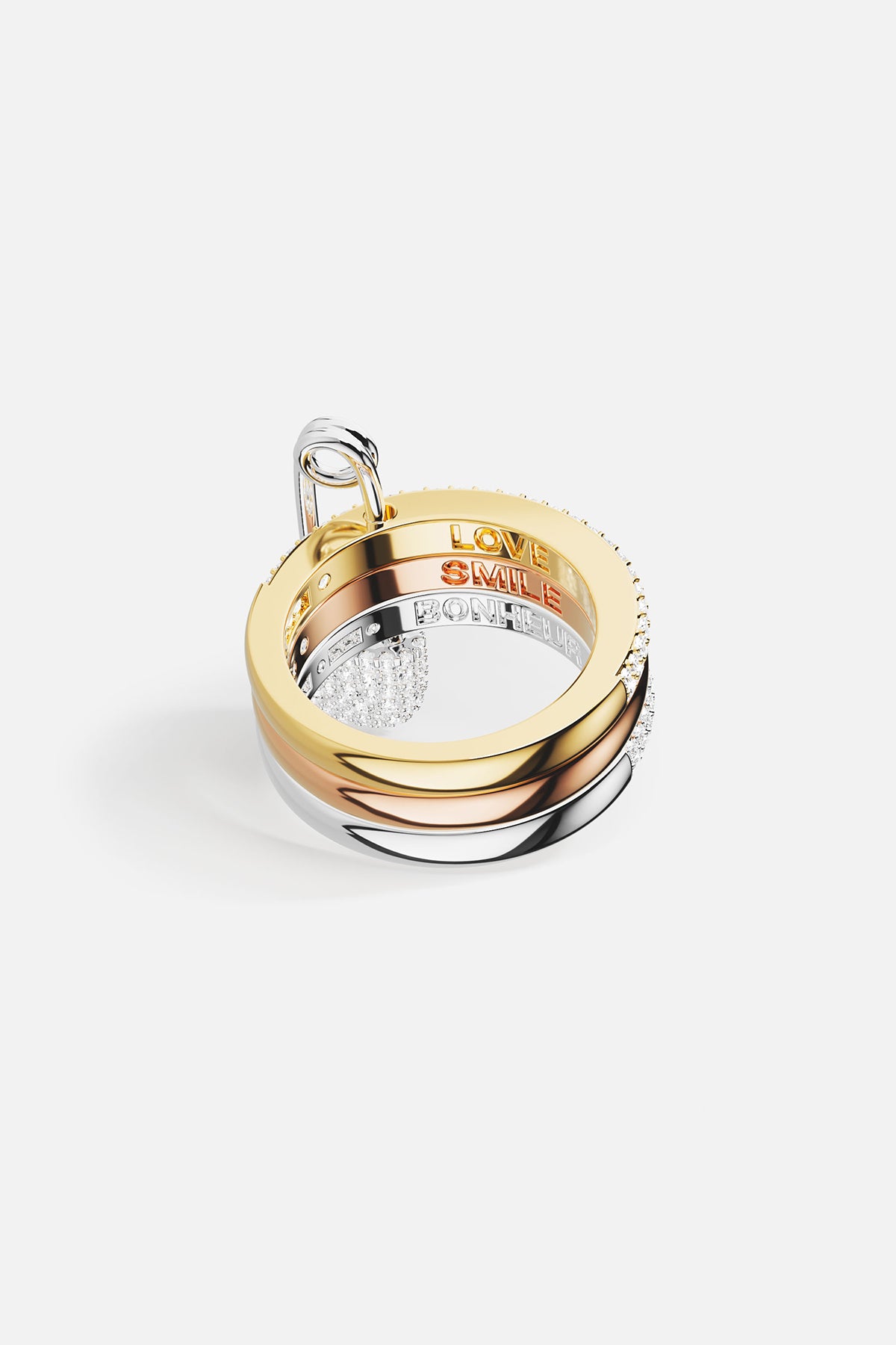 Gold and silver ring with 'LOVE' engraving on a white background