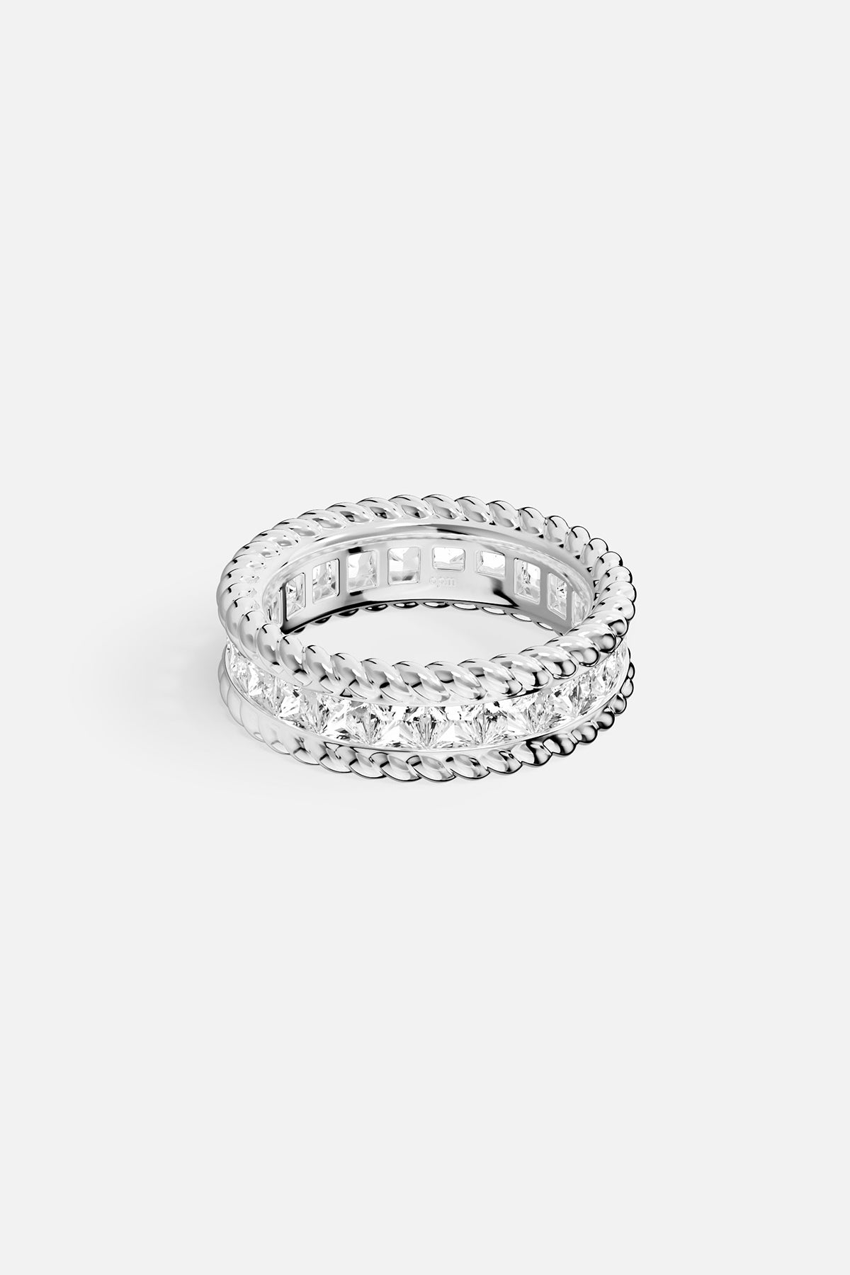 Silver ring with clear gemstones on a white background