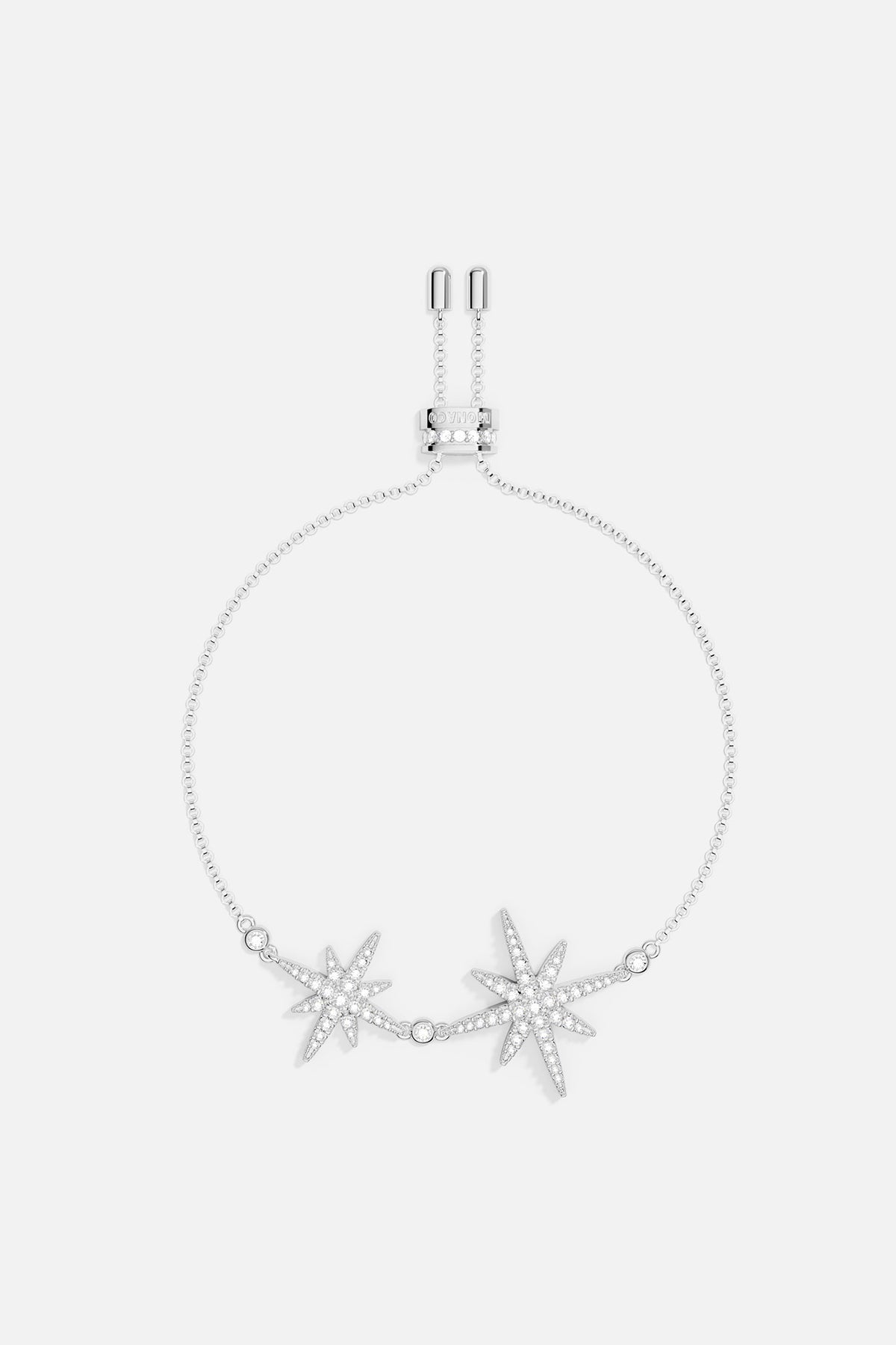 Bracelets APM Monaco: silver-tone charm bracelet with two jeweled starburst charms.