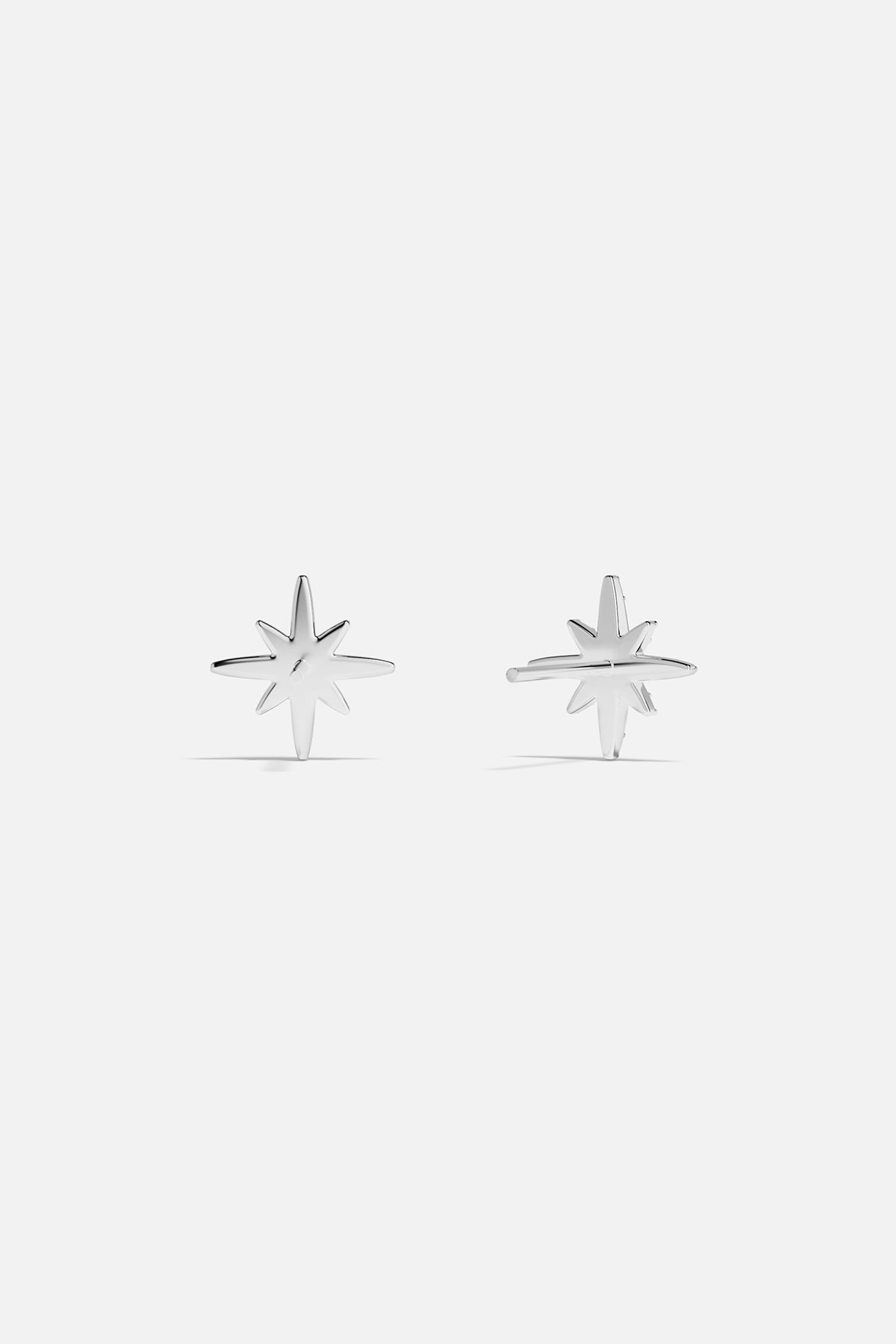 Earrings APM Monaco: Silver-tone starburst stud earrings with white stones.