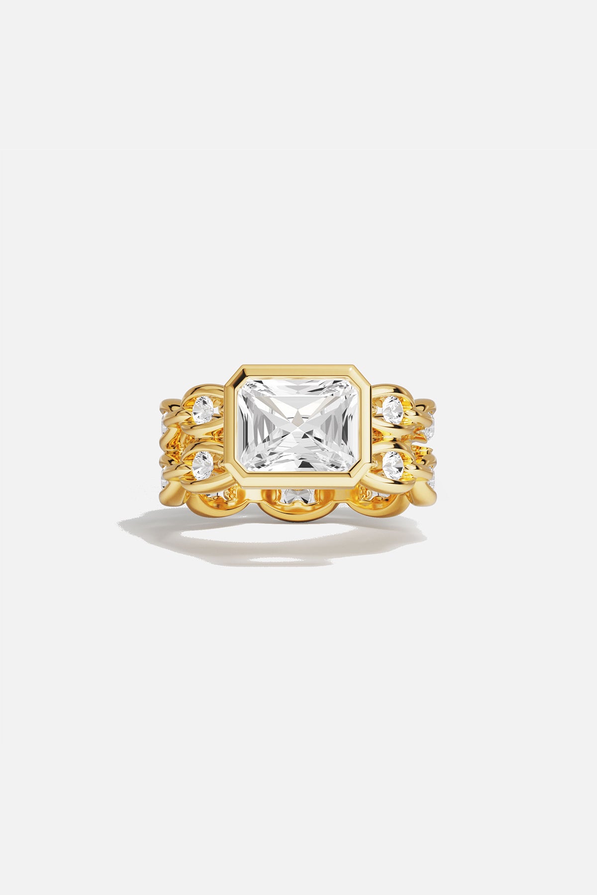 Rings APM Monaco yellow gold statement ring with a large square-cut white center stone surrounded by a pavé halo of smaller stones.