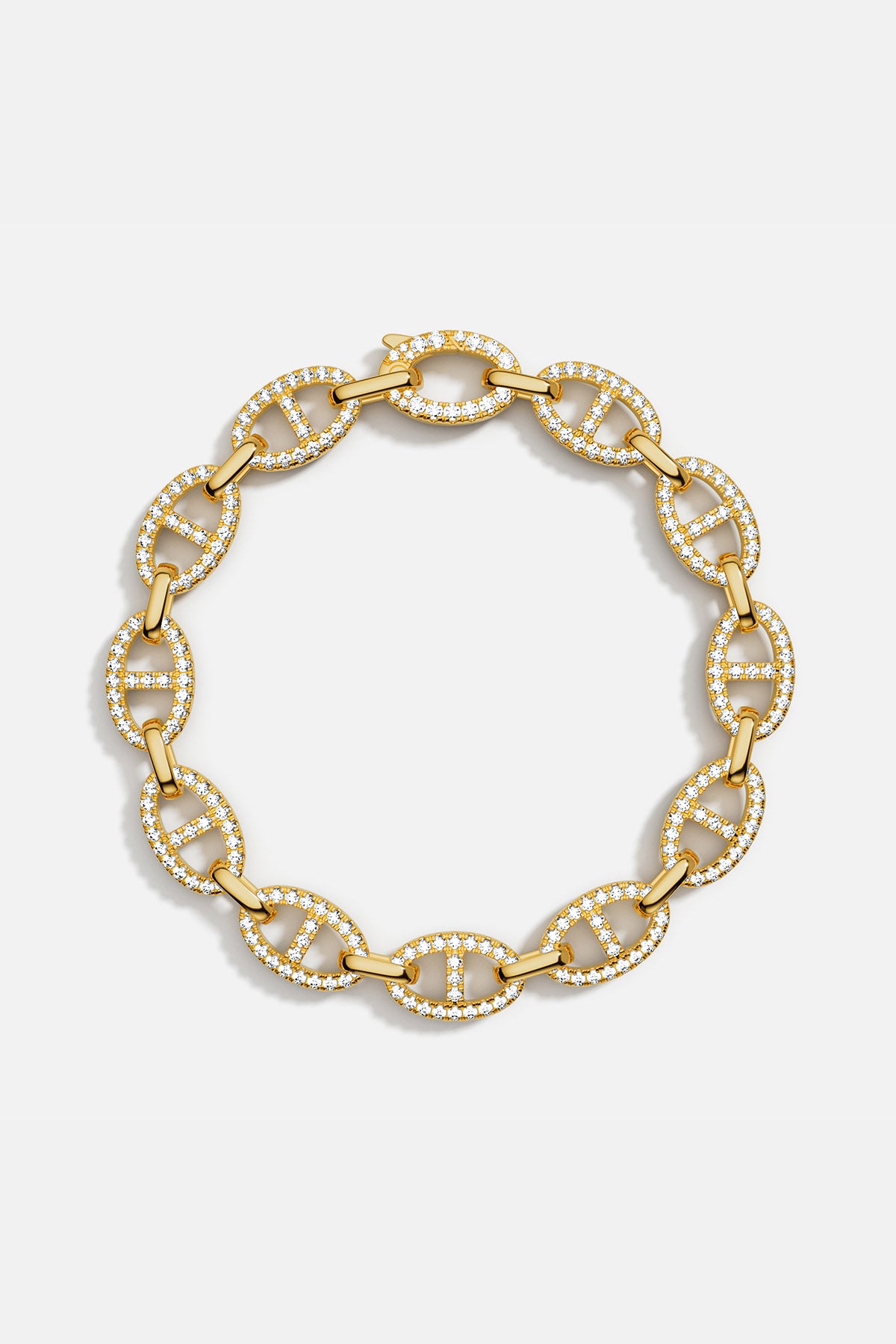 Bracelets APM Monaco: yellow gold chain link bracelet with pavé white cubic zirconia.
