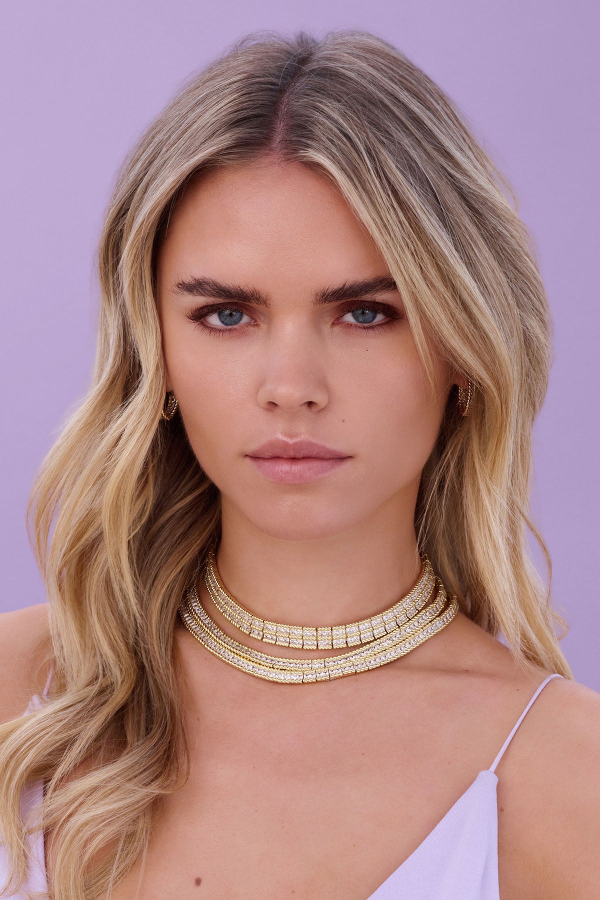 a decorative neckline against a purple background