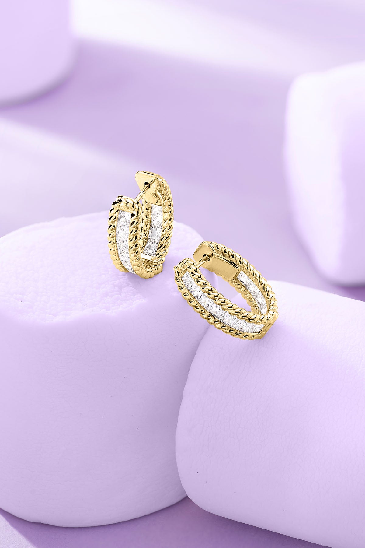 Torsade Pavé Hoop Earrings on a purple background