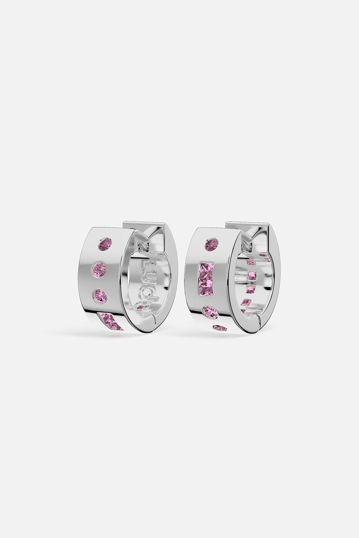 Silver hoop earrings with pink gemstones on a white background